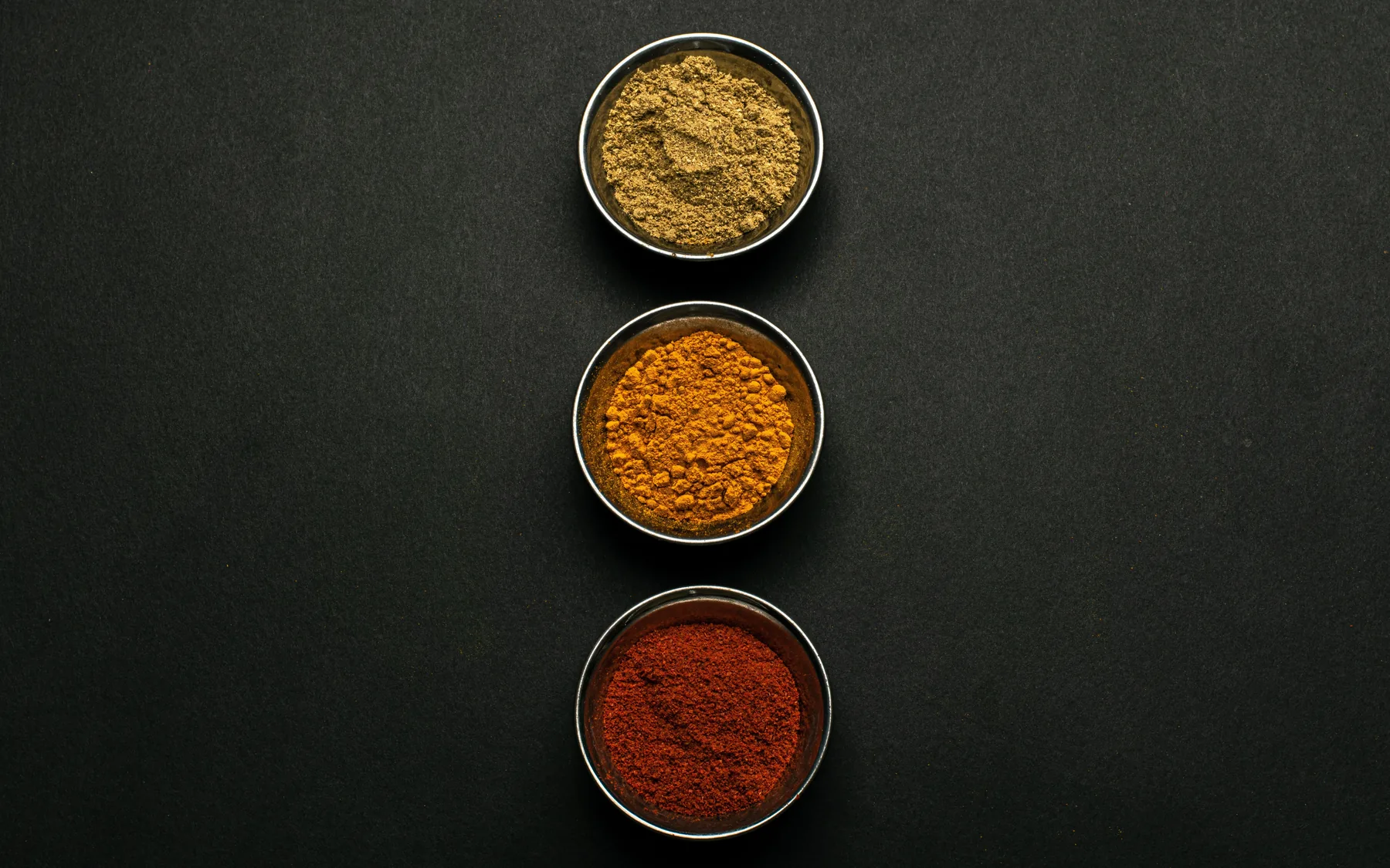 Bowls of colourful vegetable and spice powders